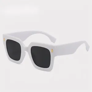 Square white thick frame sunglasses with dark lenses and gold decorative accents