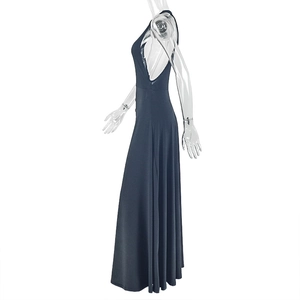 Detail view of the elegant side cutout and draped waist on this black maxi dress