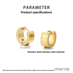Macro detail of gold stainless steel hoop earrings with Roman numeral engraving details