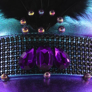 Purple carnival captain hat with rhinestones, gems, and black feathers for stage party