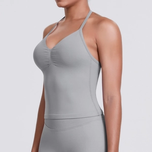Detail of light gray sports camisole showing thin straps and elastic fabric texture