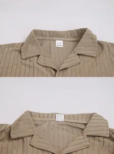 Detail showing 100% polyester fabric texture, size M label and care instructions for khaki shirt