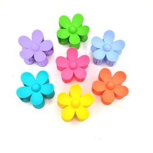 Set of 7 colorful matte flower hair claws for women in various bright candy tones