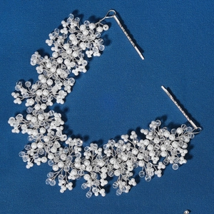 Detail of handmade bridal headband with white pearls and crystals on silver wire
