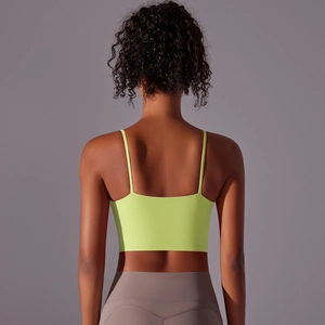Detail of cross-back design on neon green high-impact sports bra and high-waist leggings