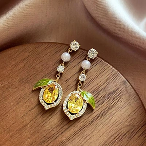 Exquisite gold lemon stud earrings with yellow gemstones, green enamel leaves and pearls