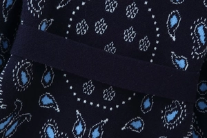 Detailed macro view of the navy paisley jacquard knit texture and intricate floral pattern
