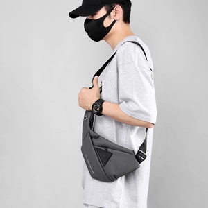 Detail view of the water-resistant gray chest bag with a sleek matte finish and side pockets
