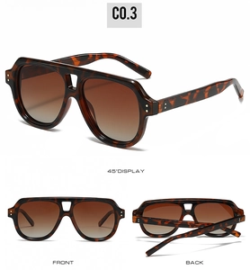 Close-up of tortoise shell aviator sunglasses with brown gradient lenses and metal rivets