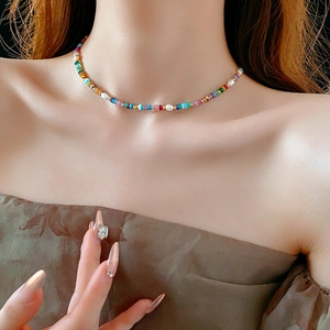 Detailed view of 18K gold plated necklace with colorful baroque pearls and beads