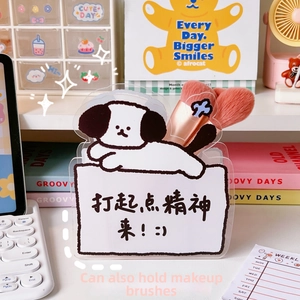 Macro shot of acrylic desk organizer with cute dog design and transparent pencil slots