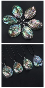 Detailed view of large natural abalone shell pendants with vibrant rainbow iridescent finish
