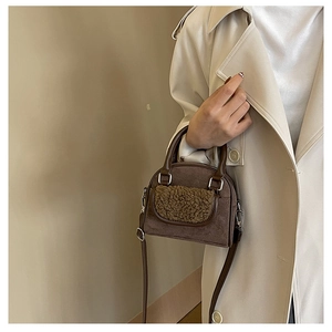 Detailed close-up of dark brown plush crossbody bag with textured suede finish