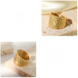 Detailed view of the gold hammered texture on an adjustable stainless steel open ring