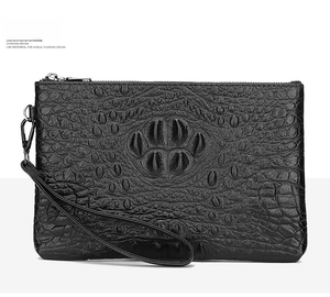 Detail of the black crocodile pattern texture on a men's faux leather clutch bag
