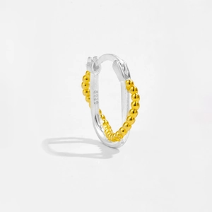Detailed macro view of S925 sterling silver hallmark on two-tone beaded hoop earrings