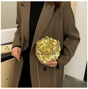 Detail of golden 3D rose evening bag with beaded handle and elegant chain strap