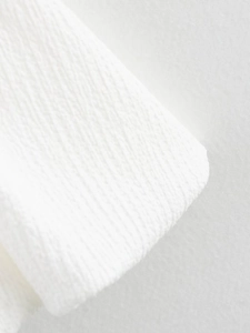 Macro shot of white woven fabric texture showing cotton linen details for balloon dress