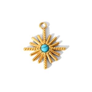 Detailed view of a golden sunburst pendant with a turquoise center stone on white backdrop