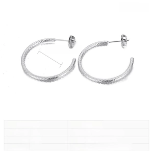 Macro shot of 30mm hammered texture silver hoop earrings in stainless steel