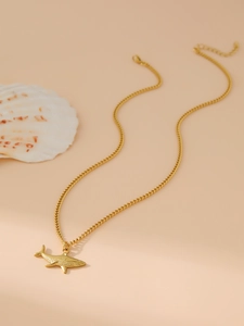 Detail view of gold shark pendant necklace with lobster clasp and adjustable chain