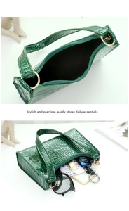 Internal storage detail of green crocodile pattern baguette bag with phone and accessories