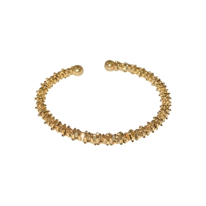 Adjustable gold geometric cuff bracelet with lava texture and spherical endpoints