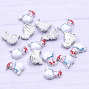 Macro shot of snowman enamel charms with red hat and blue scarf for DIY jewelry