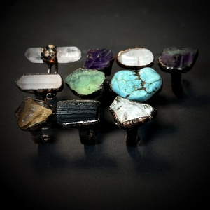 Macro shot of assorted natural crystal stones on vintage adjustable metal rings