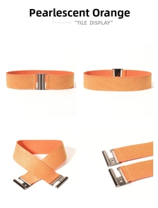 Detail view of pearlescent orange elastic wide belt with a metallic buckle and glitter finish