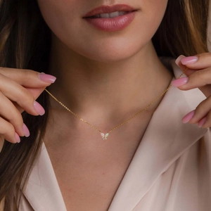 Golden butterfly necklace with iridescent opal pendant and dainty diamonds for women