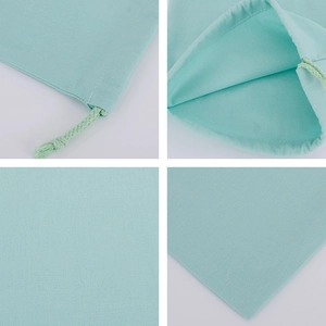 Detail view of light green canvas drawstring bag showing fabric texture and inner structure
