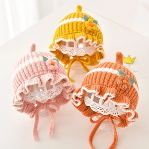 Three adorable baby girl knit ear protection hats with flowers and ruffles decor