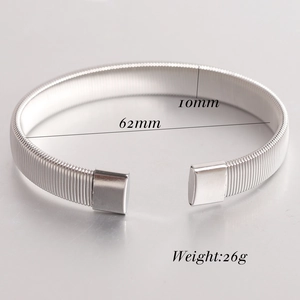 Macro shot of 6mm stainless steel stretch bracelet showing spring wire texture and dimensions