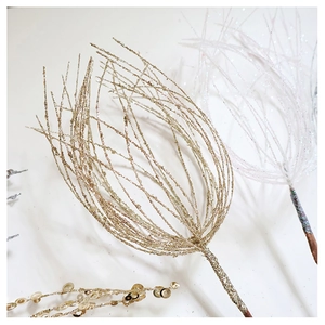 Close-up of golden and white Christmas tree picks with glitter and sequin finish
