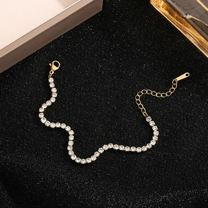 Elegant gold tennis bracelet with shimmering micro-pave cubic zirconia on black background