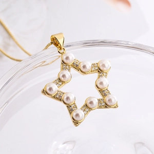 Detail of star pendant necklace with white pearls and sparkling zircons in gold finish