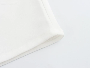 Close-up of premium white fabric texture and durable double stitching on this camisole
