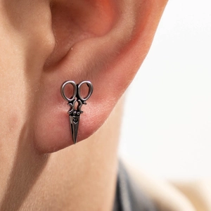 Unique stainless steel scissors shaped stud earring shown on ear for a trendy look