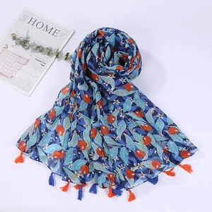 Detail of blue cotton linen scarf with cherry print and colorful decorative tassels