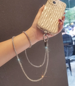 Luxurious rhinestone neck strap with white wave phone case in hand demonstration