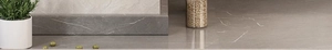 Detailed close-up of grey marble tile flooring with natural white veins and smooth texture
