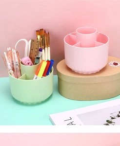 Close-up of rotating desk organizer with six compartments in green and pink pastel colors