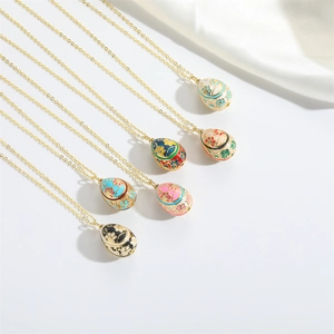 Macro detail of six colorful enamel egg pendants with golden floral engravings