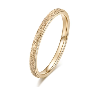 Detailed view of slim gold ring with frosted sandblasted texture and polished inner finish