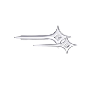 Macro detail of silver four-pointed star hairpins featuring sparkling zircon center stones