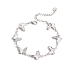 Macro detail of silver stainless steel butterfly bracelet links with textured patterns