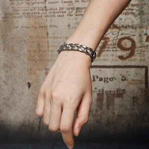 Men's vintage silver stainless steel Cuban link bracelet on male model wrist