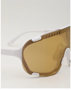 Detail of white cycling sunglasses featuring six ventilation holes on brown tinted lenses