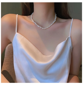 Elegant baroque irregular freshwater pearl necklace worn on model neck short choker style